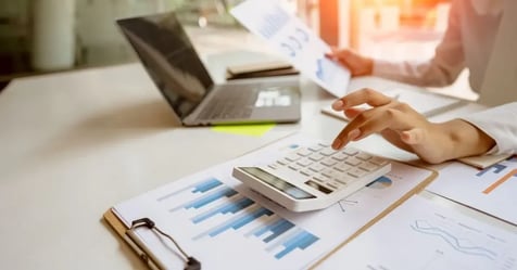 Cropped image of a travel manager crunching meeting costs on a calculator 