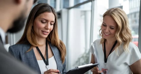 Executive Assistant using a clipboard from her meeting essentials kit