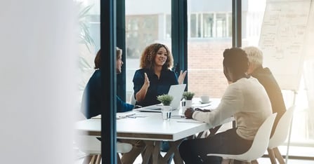 Executive Assistants planning in-person meetings in an office