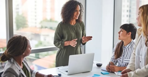 HR team in an office talking about the meeting culture and in-person meeting